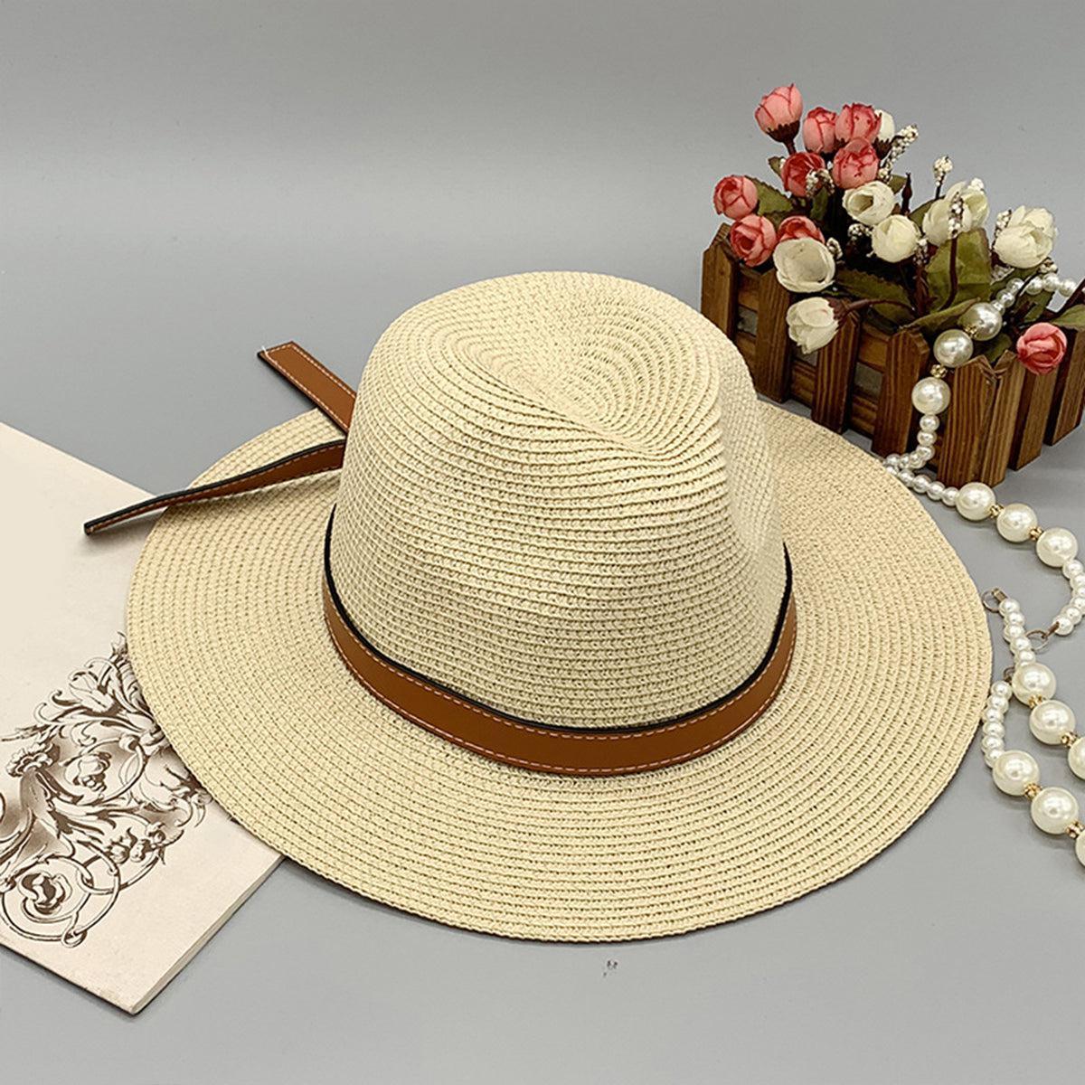 a hat, a necklace, and a card on a table