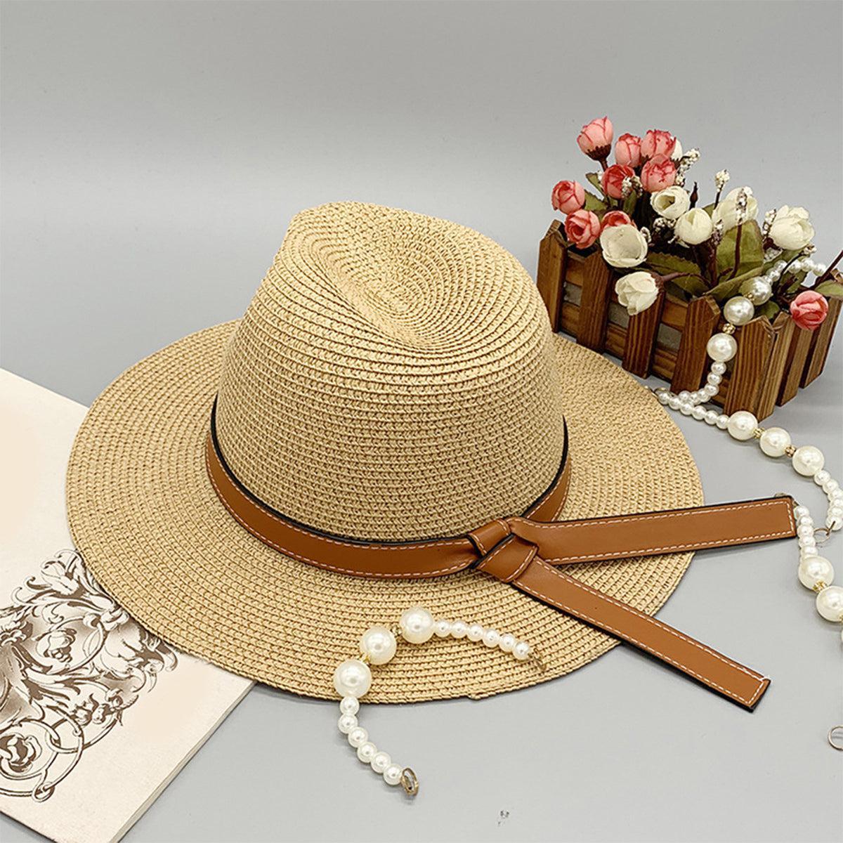 a hat, pearls, and a book on a table