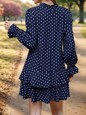 a woman is walking down a path in a dress