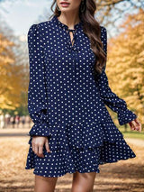 a woman wearing a blue polka dot dress