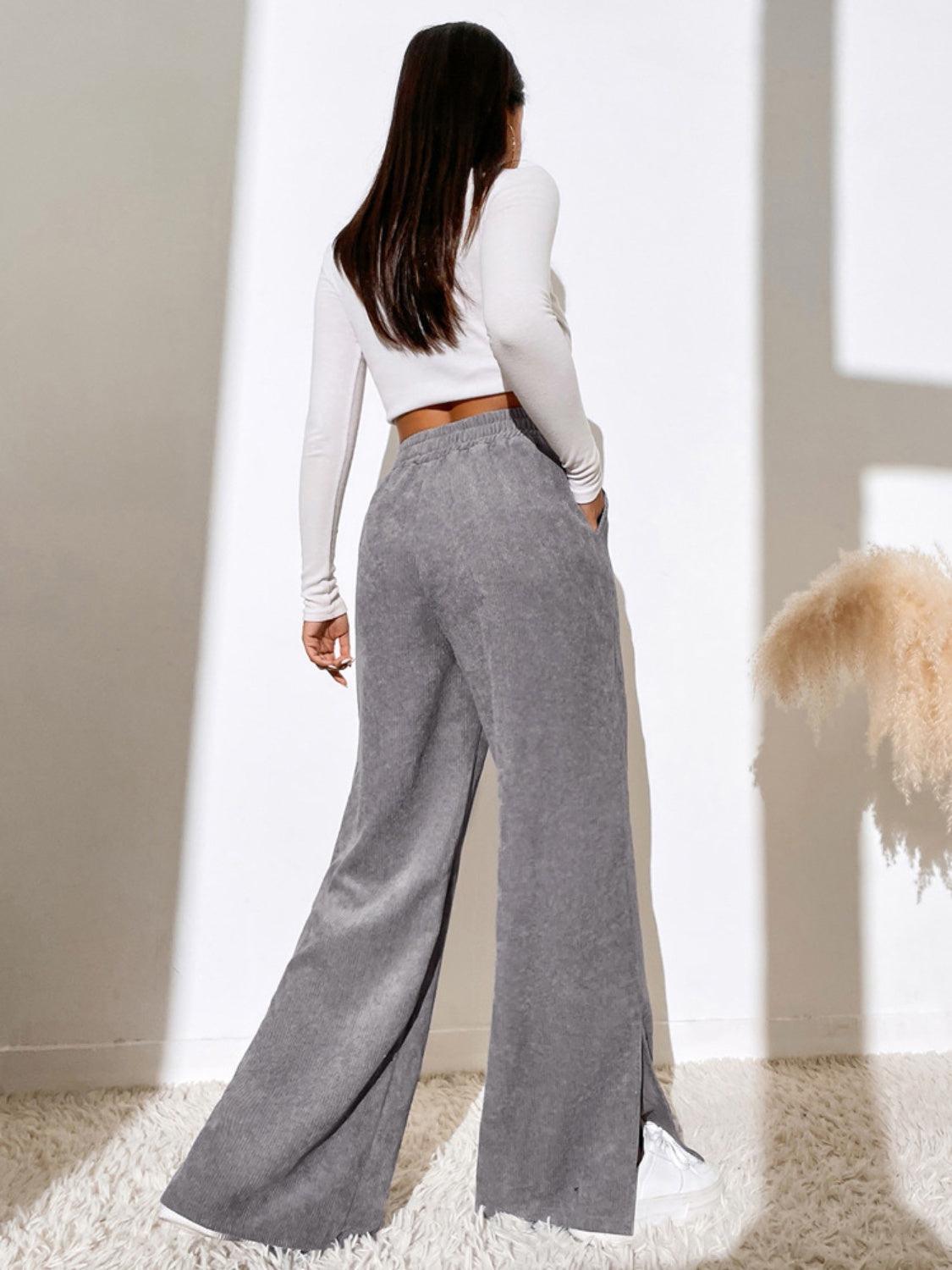 a woman standing in a room with her back to the camera