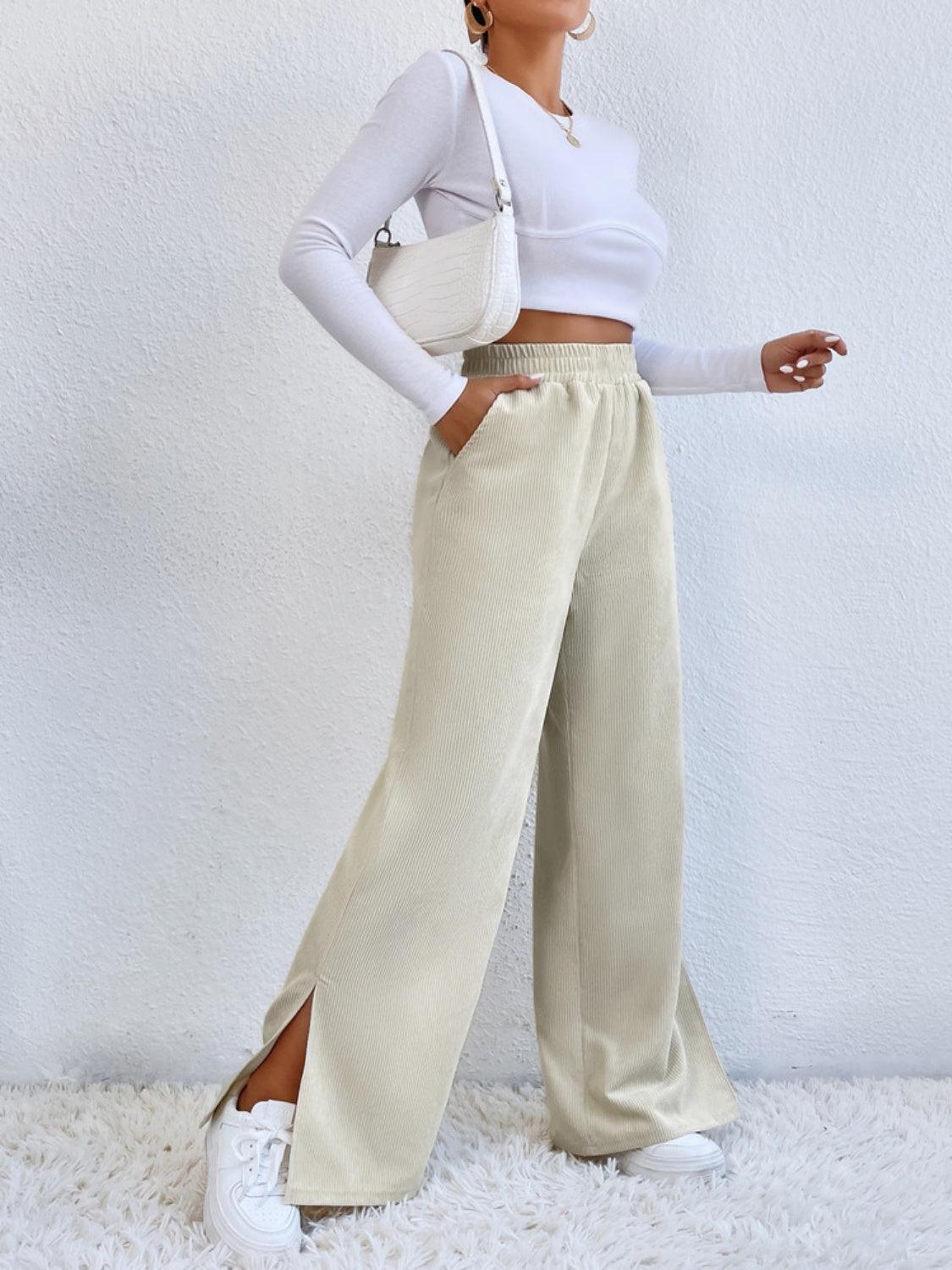 a woman in a white top and beige pants