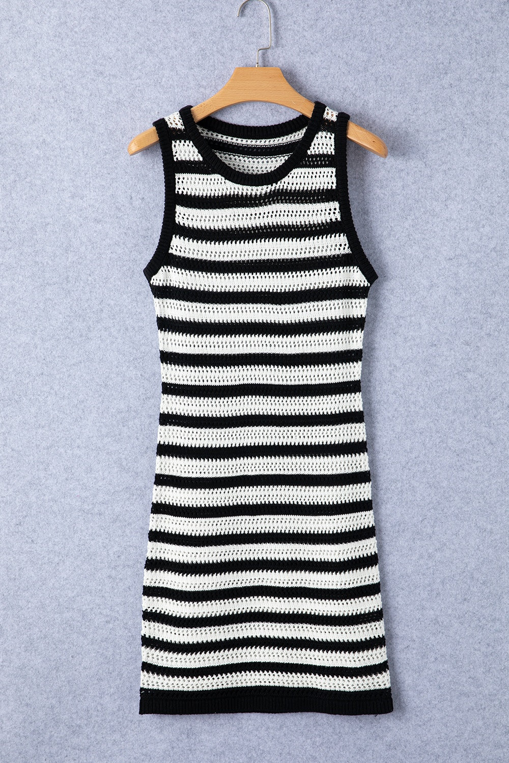 a black and white striped dress hanging on a hanger