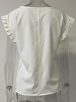 the back of a woman's white blouse with ruffles