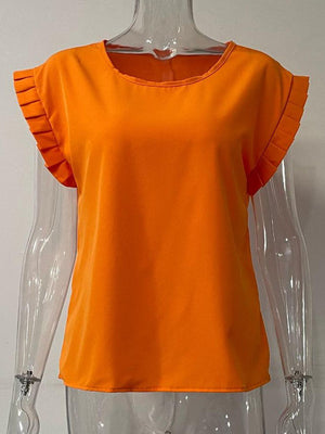 a mannequin wearing an orange top with ruffles