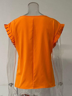 a mannequin wearing an orange top with ruffles