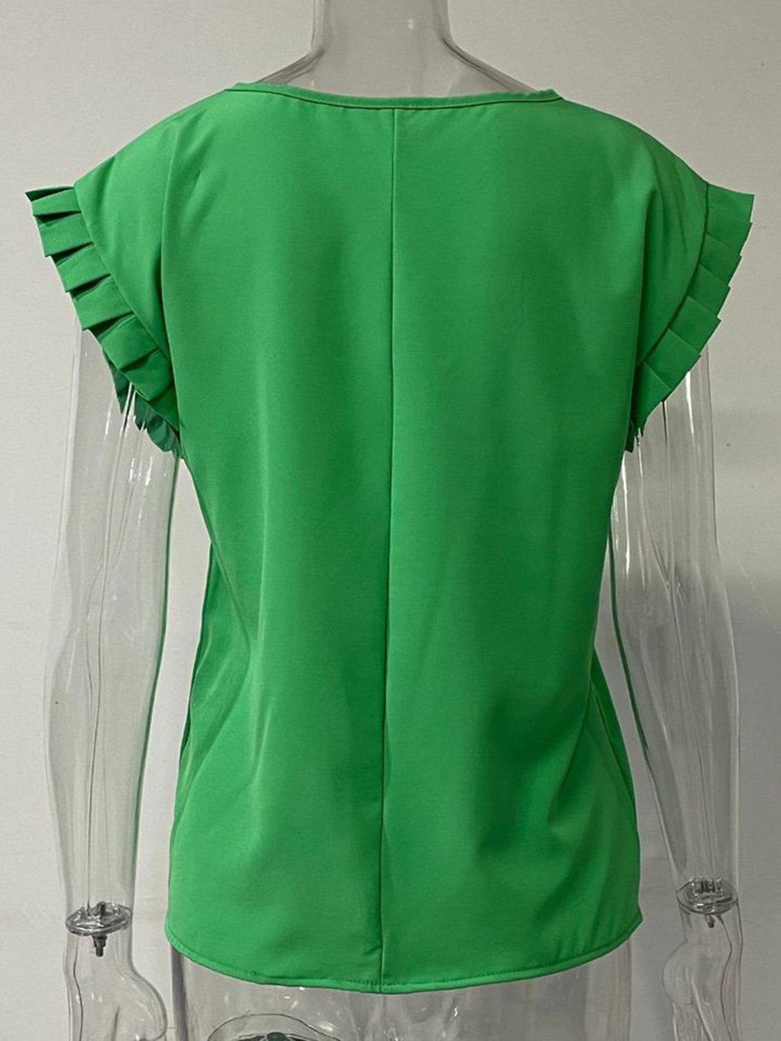 a mannequin wearing a green top with ruffles