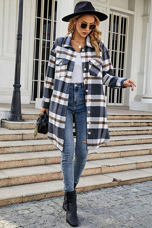 a woman wearing a plaid coat and jeans