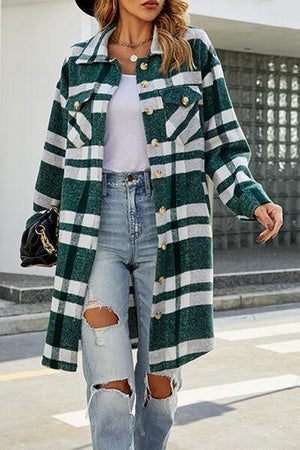 a woman wearing ripped jeans and a green and white coat