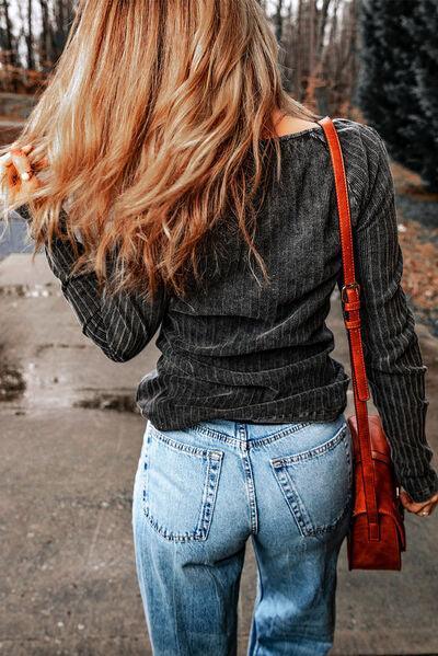 a woman with long hair walking down a street