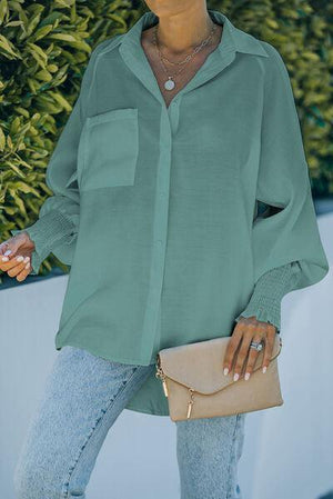 a woman wearing a green shirt and jeans
