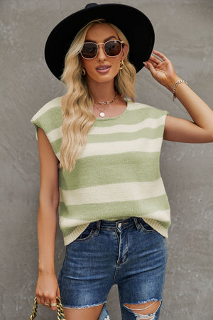 a woman wearing ripped jeans and a striped top