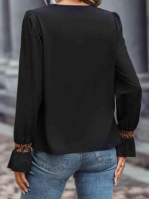 a woman wearing a black blouse and jeans