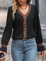 a woman wearing a black top with a leopard print on it