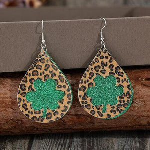 a pair of leopard print earrings with green glitter