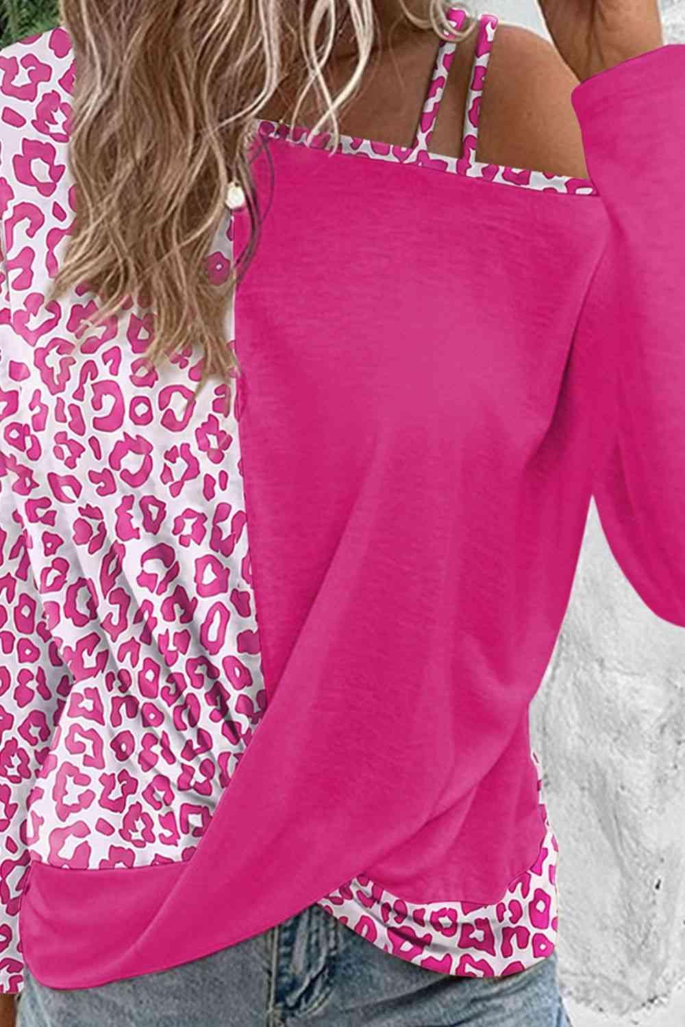 a woman wearing a pink top with a leopard print