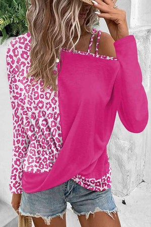 a woman wearing a pink top with leopard print