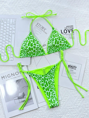 a green and white bikini top and a magazine