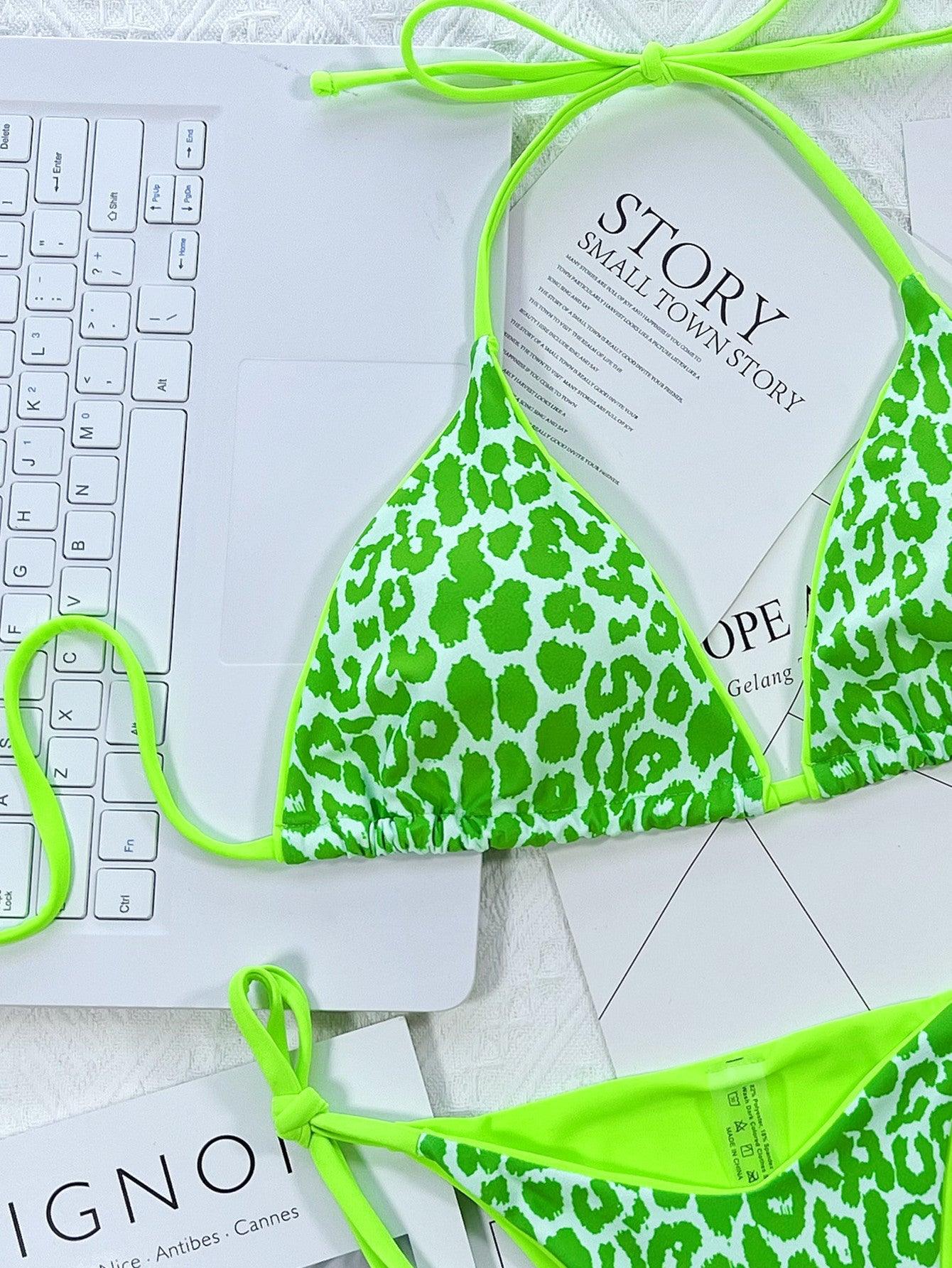 a green and white bikini with a laptop on the side