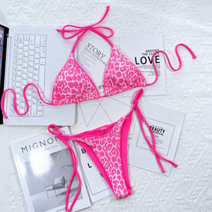 a pink and white bikini with a pink ribbon