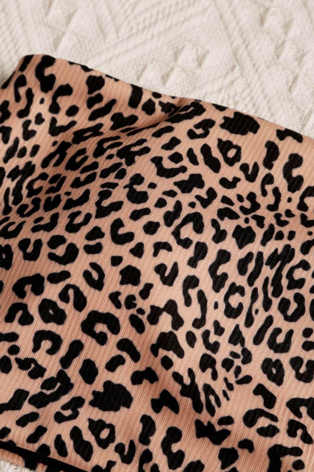 a close up of a leopard print fabric on a bed