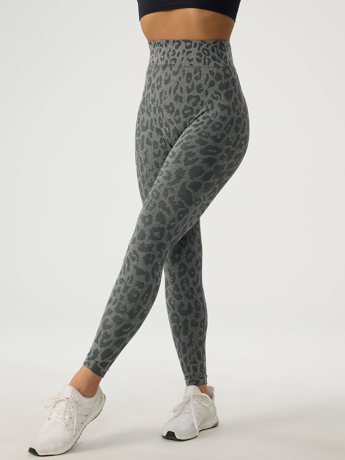 a woman in a black top and grey leopard print leggings