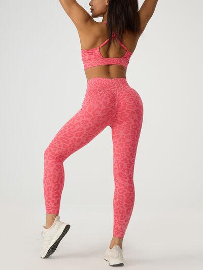 a woman in a pink sports bra top and patterned leggings