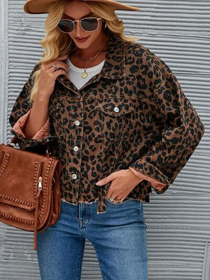 a woman wearing a leopard print shirt and jeans