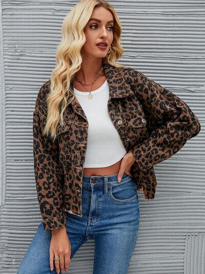a woman wearing a leopard print jacket and jeans