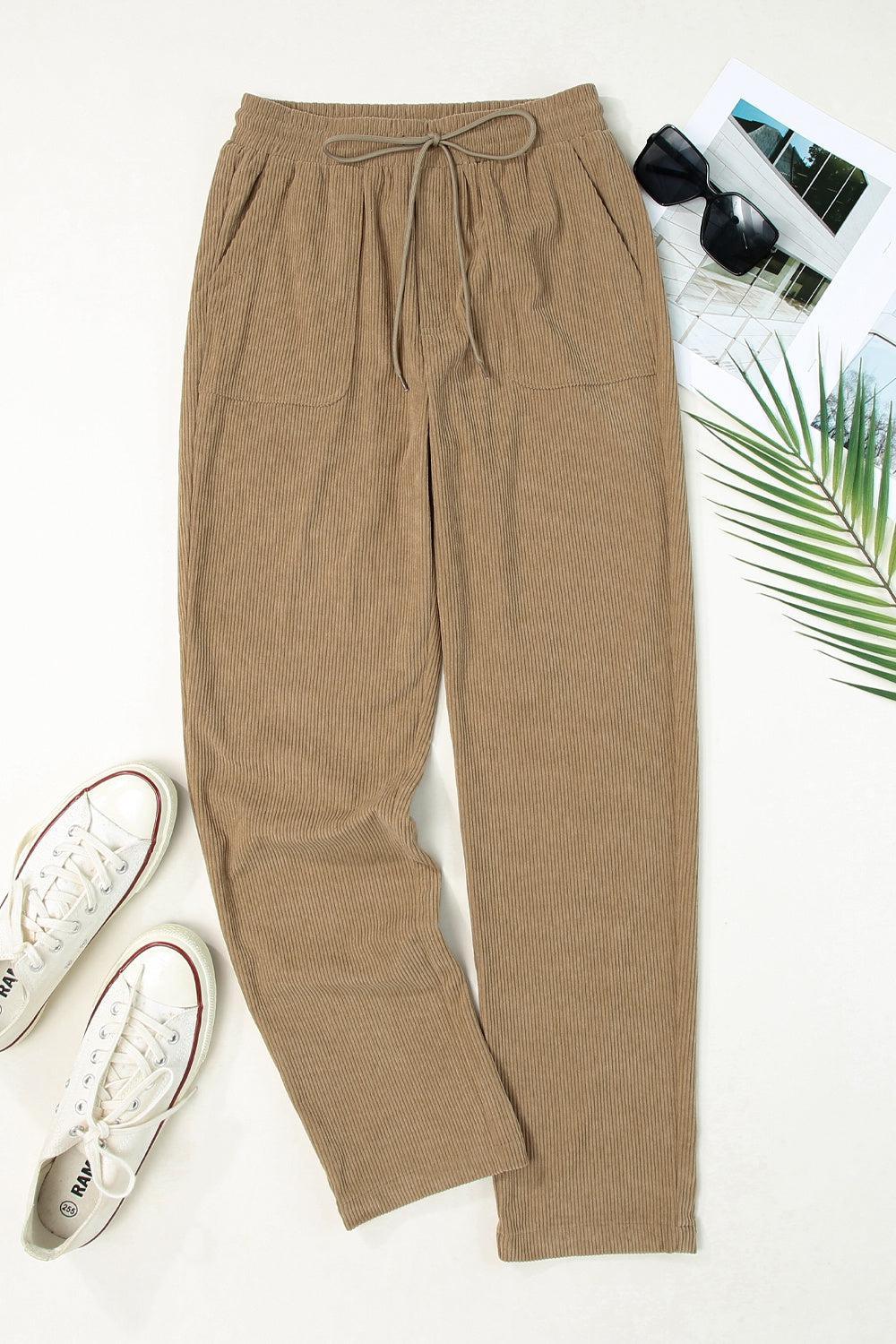 a pair of brown pants and a pair of white sneakers