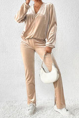 a woman in a gold outfit holding a white purse