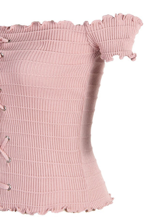 a pink corset with ruffles on it