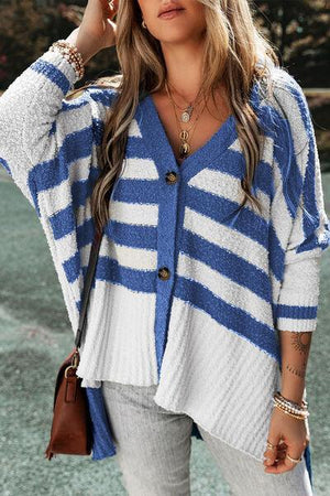 a woman wearing a blue and white striped cardigan