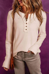 a woman wearing a white shirt and jeans