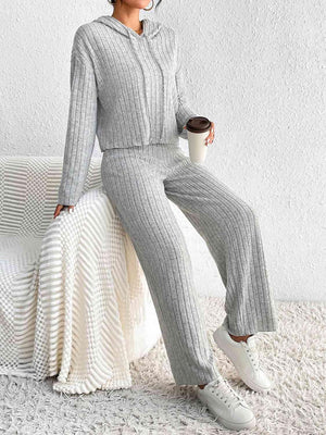 a woman sitting on a bed with a cup of coffee