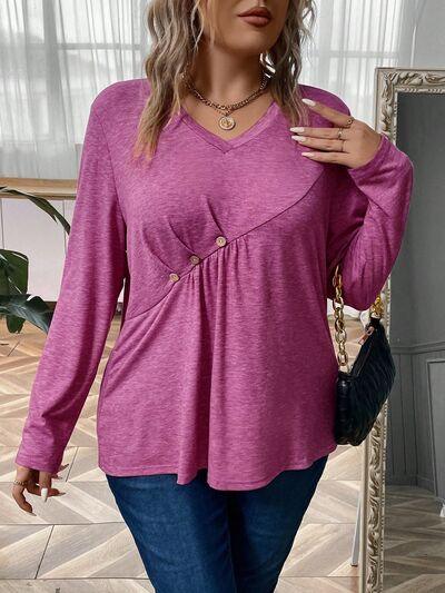 a woman wearing a pink top and jeans