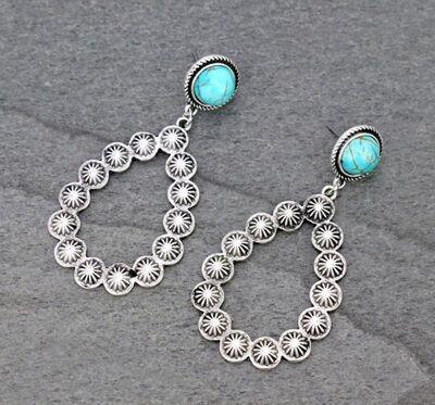 a pair of silver and turquoise earrings