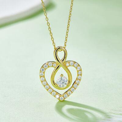 a gold necklace with a heart shaped diamond