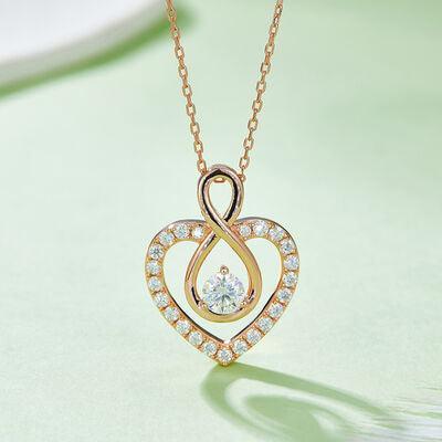 a heart shaped pendant with a diamond on a chain