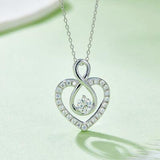 a heart shaped diamond pendant on a chain