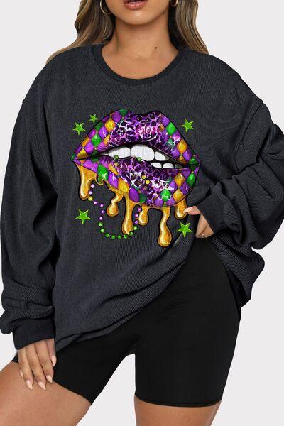 a woman wearing a black sweatshirt with a colorful lip on it