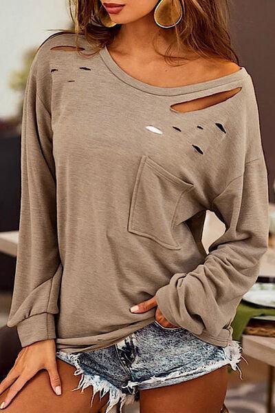 a woman wearing a sweater with holes on it