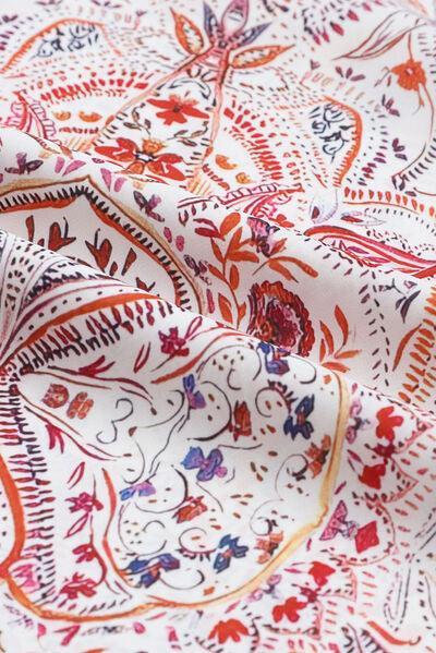 a close up of a red and white paisley print fabric