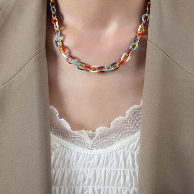 a woman wearing a jacket and a multicolored necklace