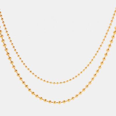 a gold ball chain necklace on a white background