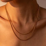 a close up of a woman wearing a necklace