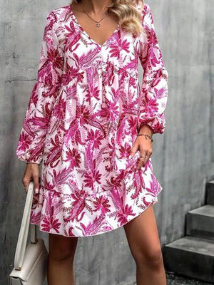 a woman in a pink and white floral print dress