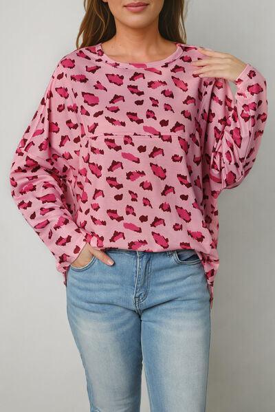 a woman wearing a pink top with hearts on it