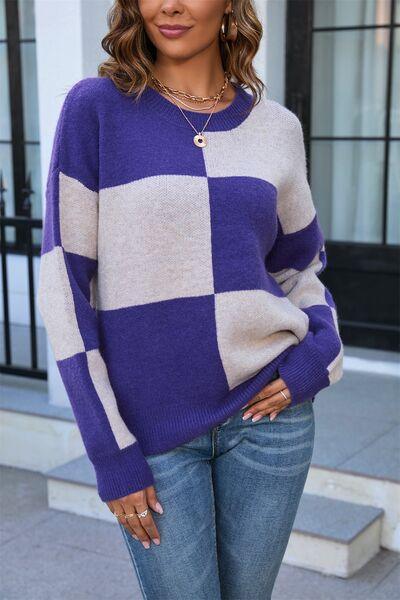 a woman wearing a purple and white checkered sweater