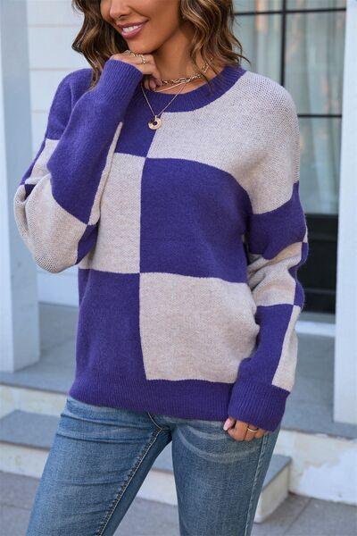 a woman wearing a purple and white checkered sweater